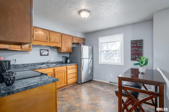 a kitchen with stainless steel appliances granite countertop sink stove top oven and cabinets