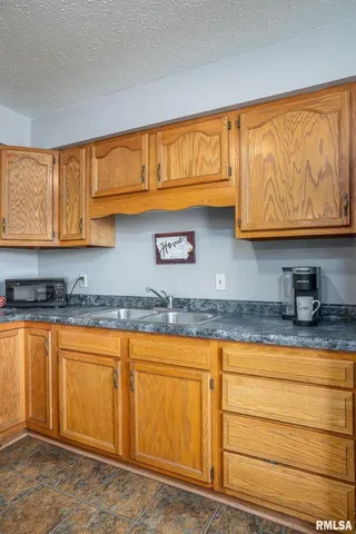 a kitchen with stainless steel appliances granite countertop a sink and cabinets