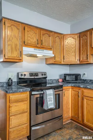 a kitchen with stainless steel appliances granite countertop a stove and a sink