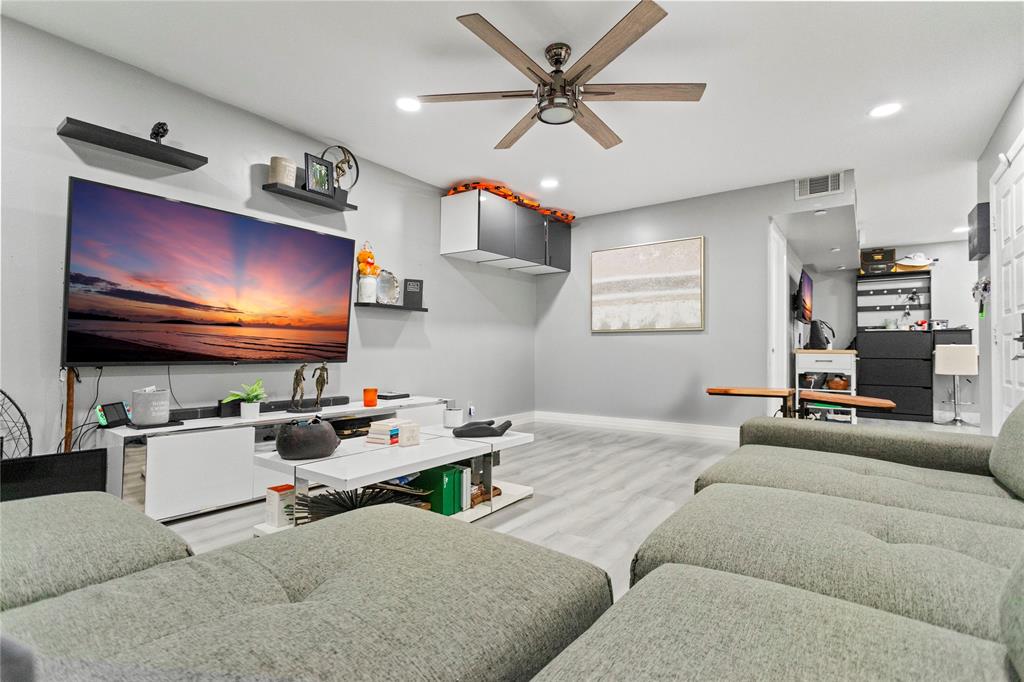 22940 Oxford Place, Unit C Boca Raton, FL 33433 - Photo 12 of 60 a living room with furniture and a flat screen tv