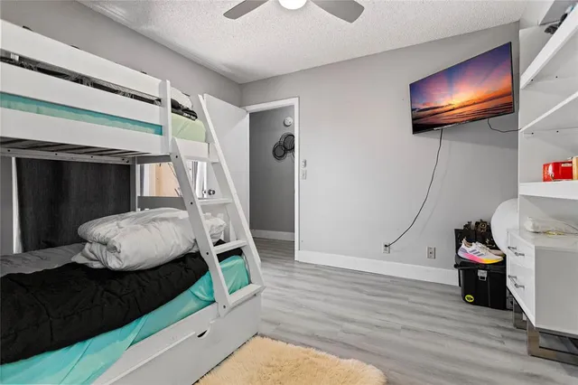 a bathroom with a sink vanity granite toilet and shower