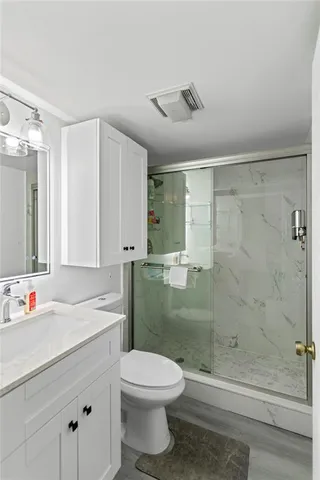 a bathroom with a shower and a sink