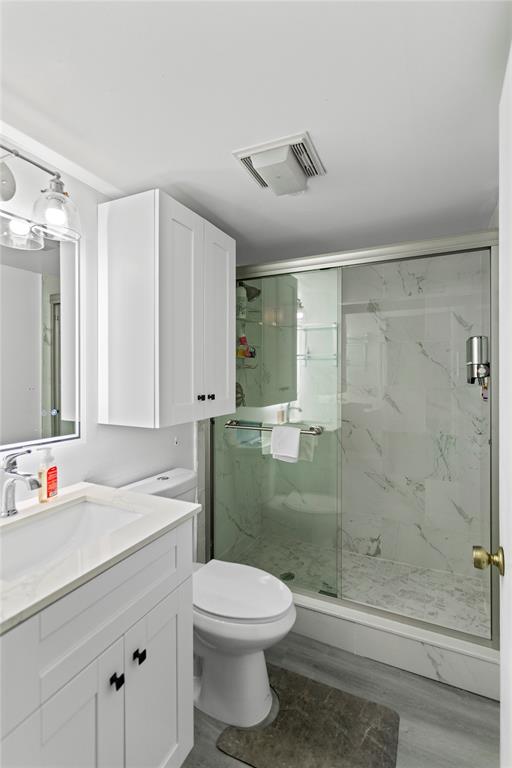 22940 Oxford Place, Unit C Boca Raton, FL 33433 - Photo 18 of 60 a bathroom with a sink a toilet and shower