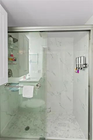 a bathroom with a sink toilet vanity and tub