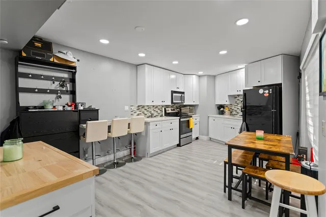 a kitchen with a table chairs and a refrigerator