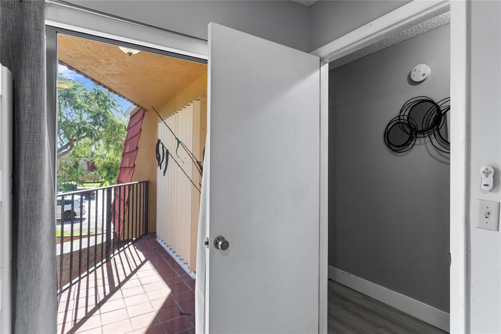 22940 Oxford Place, Unit C Boca Raton, FL 33433 - Photo 21 of 60 a view of a porch with wooden floor and door