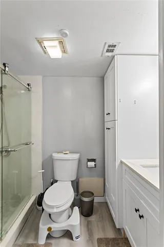 a bathroom with a glass shower door