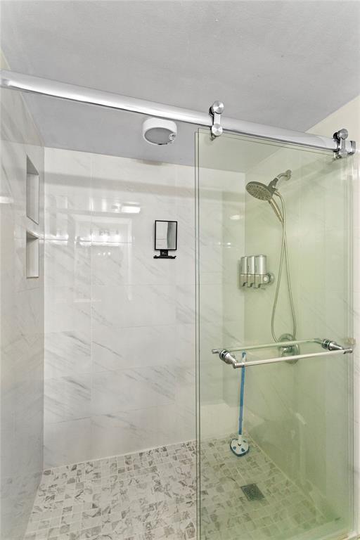 22940 Oxford Place, Unit C Boca Raton, FL 33433 - Photo 32 of 60 a bathroom with a glass shower door