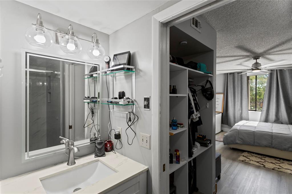 22940 Oxford Place, Unit C Boca Raton, FL 33433 - Photo 34 of 60 a bathroom with a tub sink and a mirror