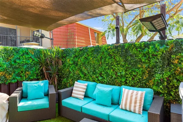 a living room with furniture a flat screen tv and a toilet