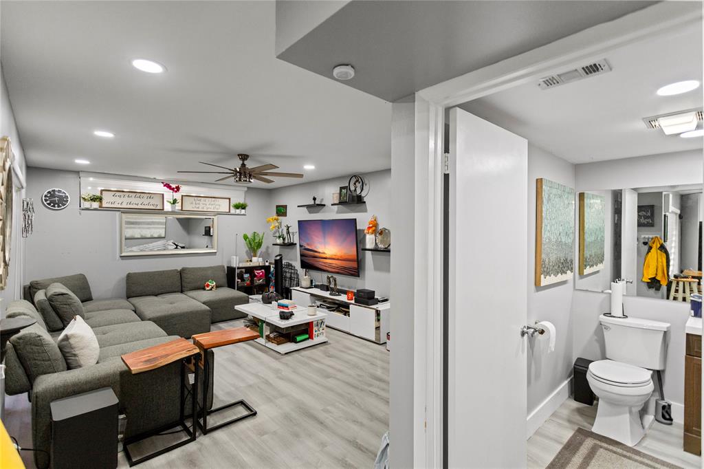 22940 Oxford Place, Unit C Boca Raton, FL 33433 - Photo 44 of 60 a living room with furniture a flat screen tv and a toilet