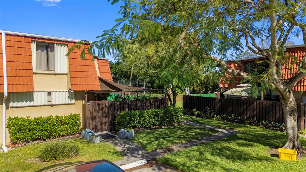 22940 Oxford Place, Unit C Boca Raton, FL 33433 - Photo 52 of 60 front view of a house with a yard