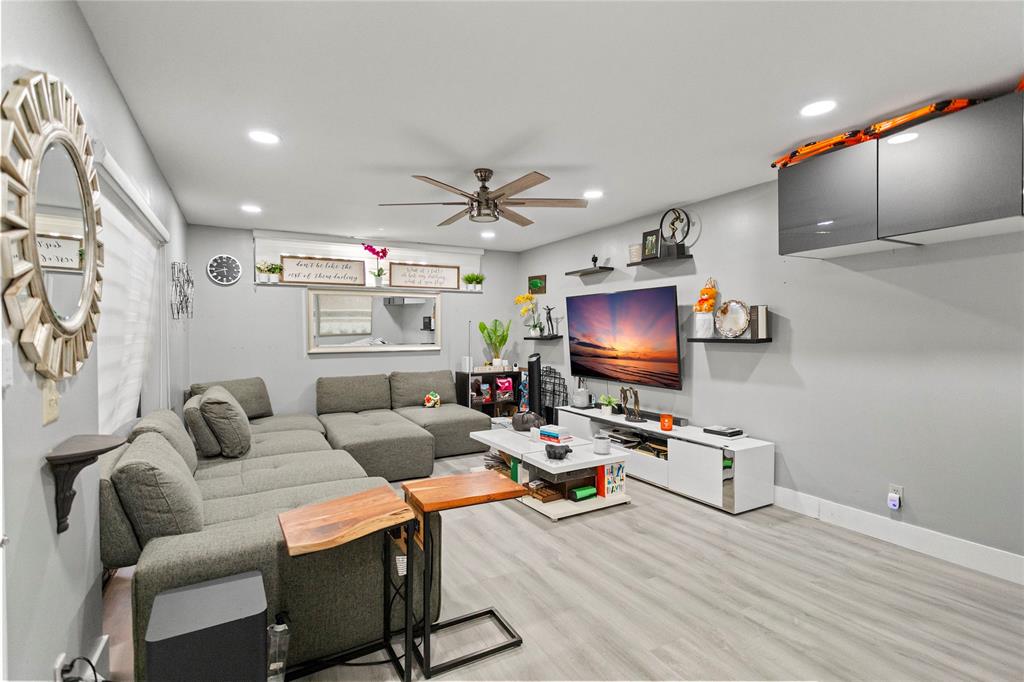 22940 Oxford Place, Unit C Boca Raton, FL 33433 - Photo 7 of 60 a living room with furniture and a flat screen tv