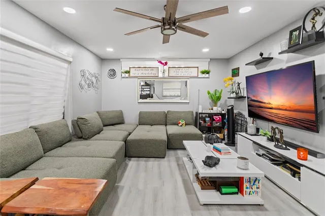 a living room with furniture and a wooden floor