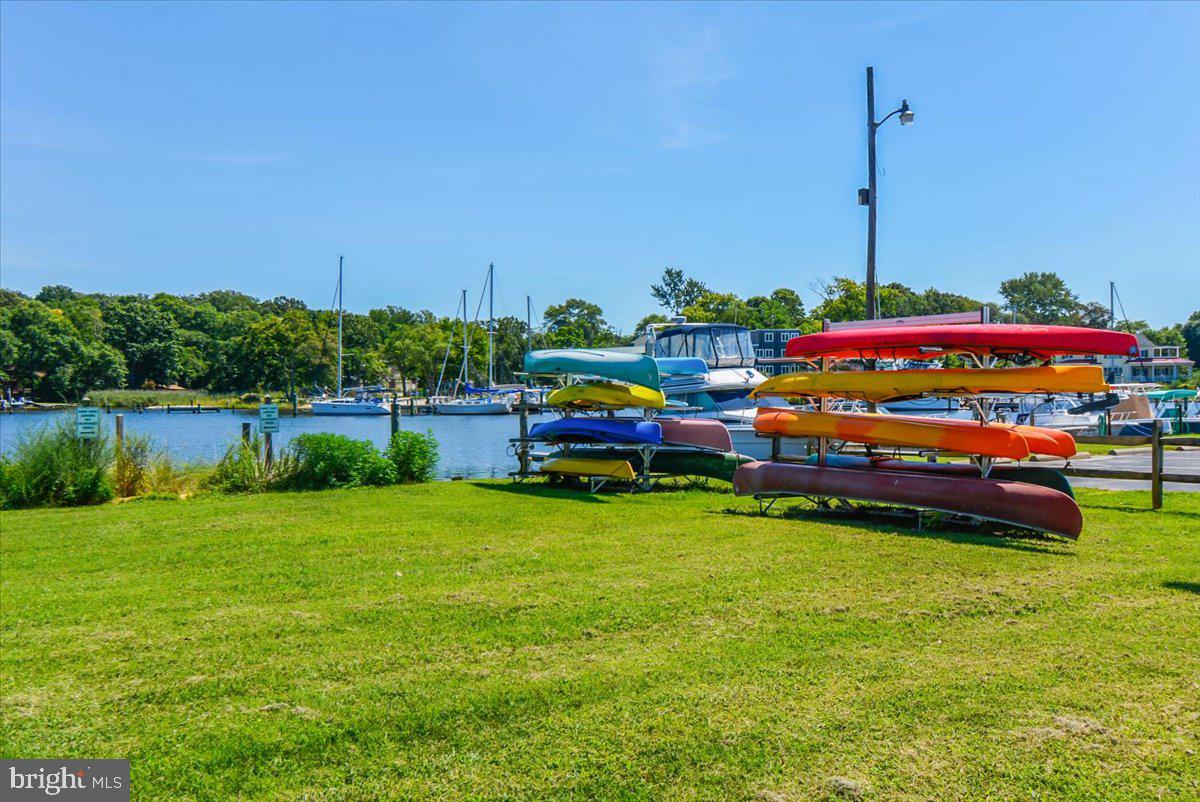 1731 Tacoma Road Edgewater, MD 21037 - Photo 52 of 59 Colorful kayaks by a serene marina.