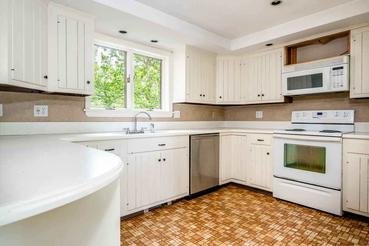 115 Pine Needle Road Wellfleet, MA 02667 - Photo 13 of 37 a kitchen with a stove sink and cabinets