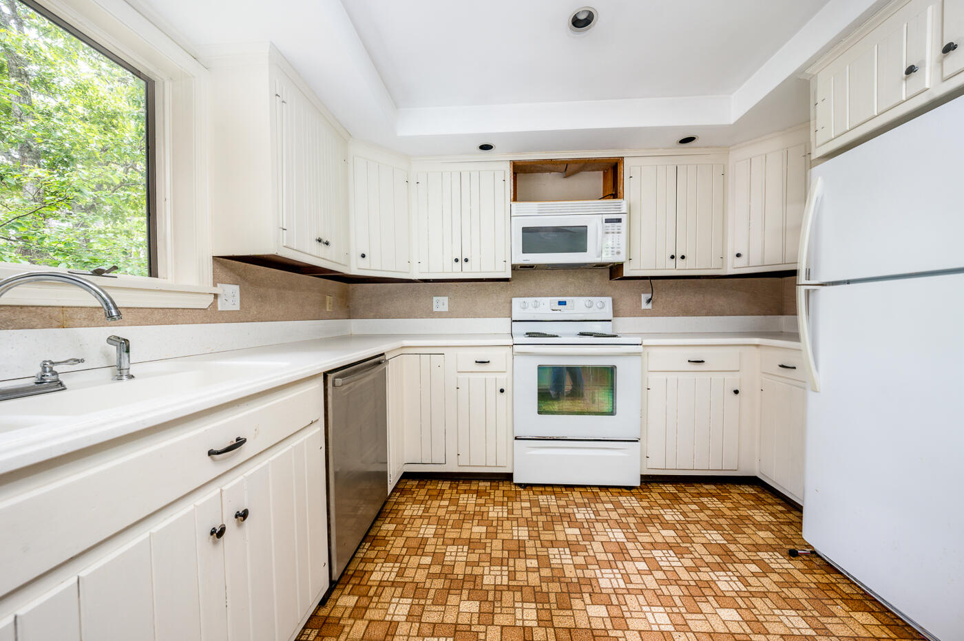 115 Pine Needle Road Wellfleet, MA 02667 - Photo 14 of 37 a kitchen with granite countertop white cabinets and white appliances