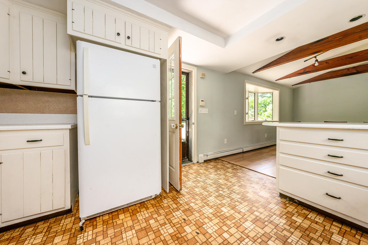 115 Pine Needle Road Wellfleet, MA 02667 - Photo 15 of 37 a view of a kitchen with refrigerator and cabinet