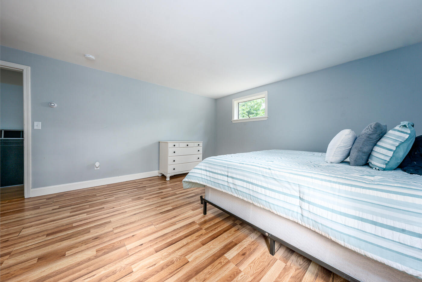 115 Pine Needle Road Wellfleet, MA 02667 - Photo 18 of 37 a bedroom with a bed and wooden floor