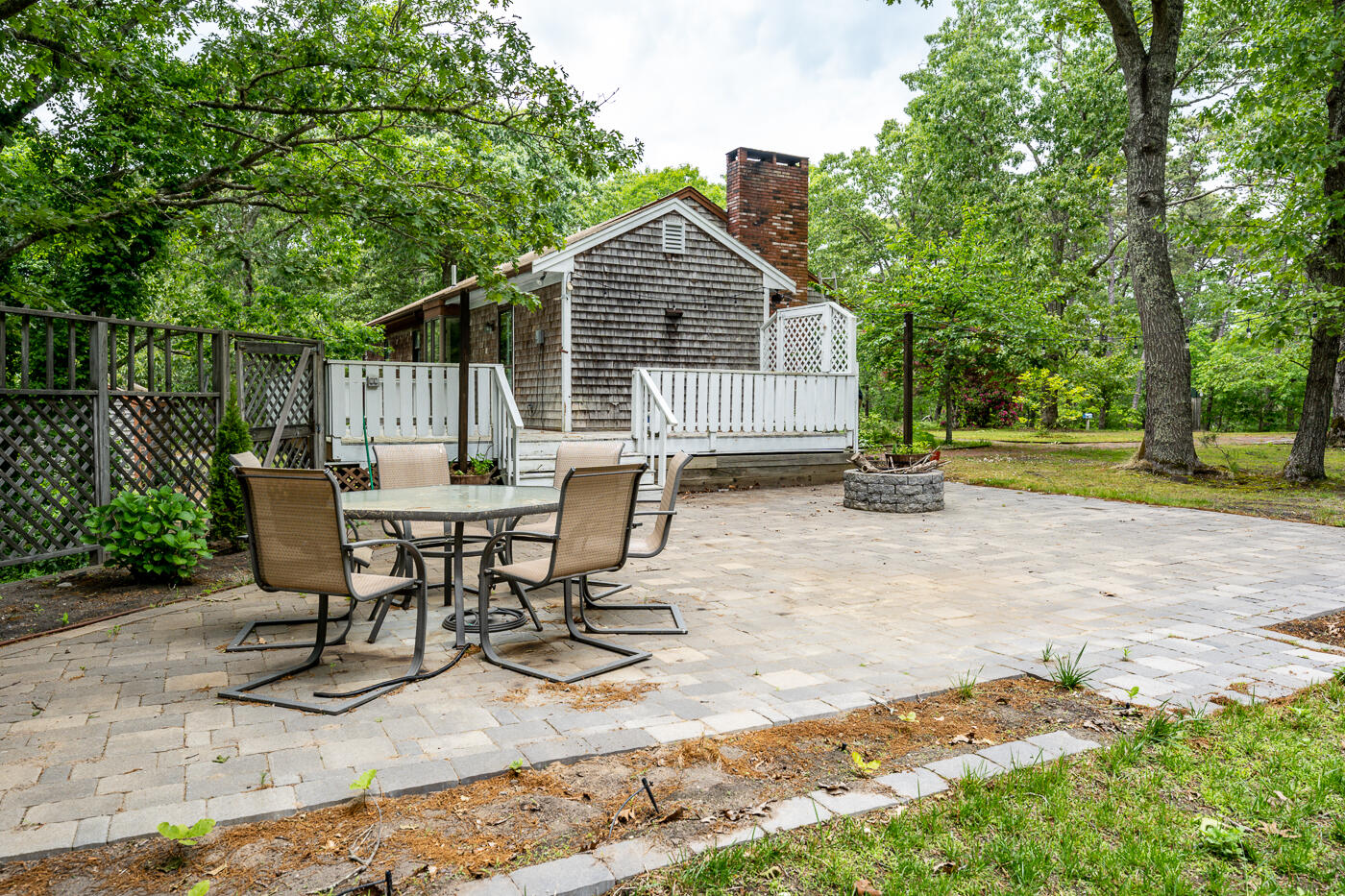 115 Pine Needle Road Wellfleet, MA 02667 - Photo 21 of 37 a view of house with table and chairs in patio