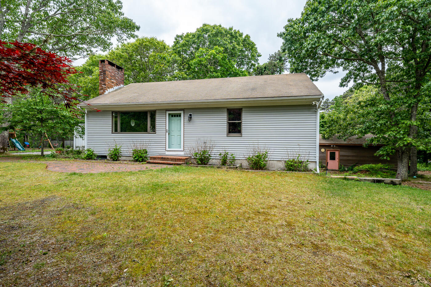 115 Pine Needle Road Wellfleet, MA 02667 - Photo 35 of 37 a front view of house with yard and trees