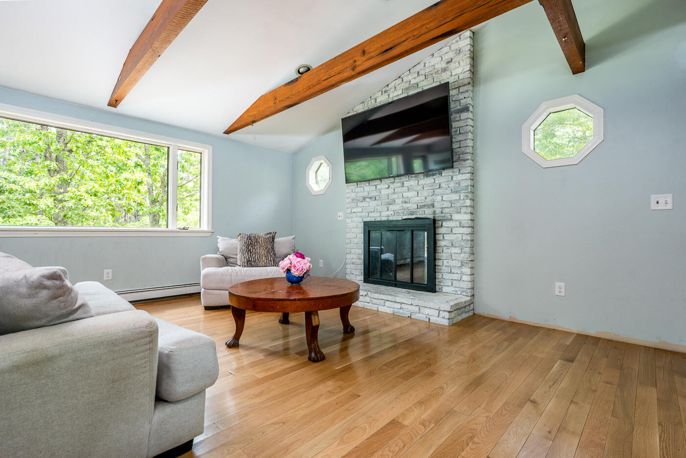 115 Pine Needle Road Wellfleet, MA 02667 - Photo 8 of 37 a living room with furniture and a fireplace