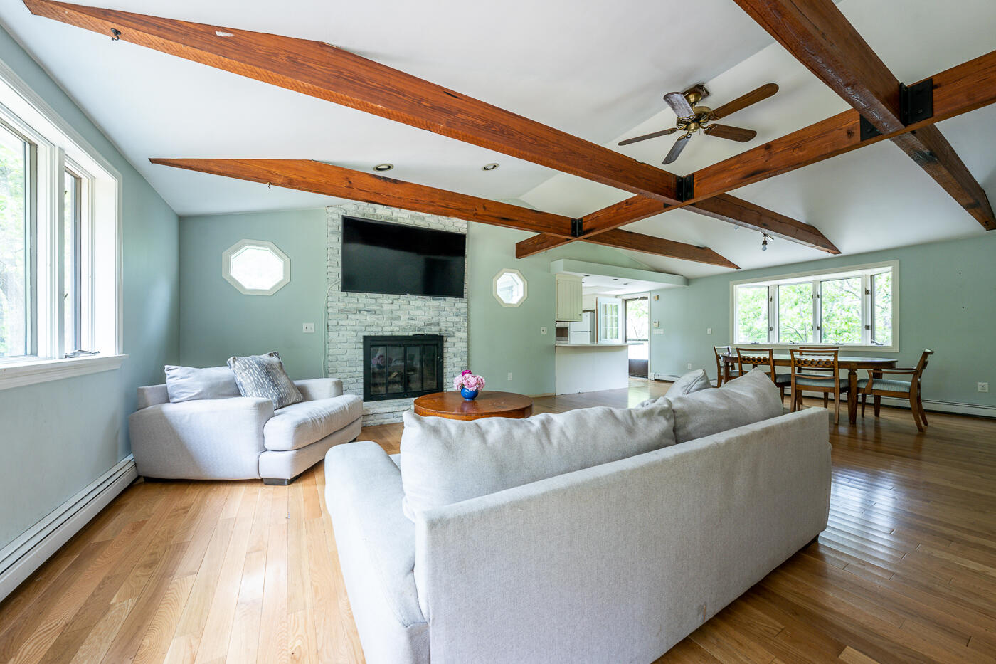 115 Pine Needle Road Wellfleet, MA 02667 - Photo 9 of 37 a living room with fireplace furniture and a wooden floor
