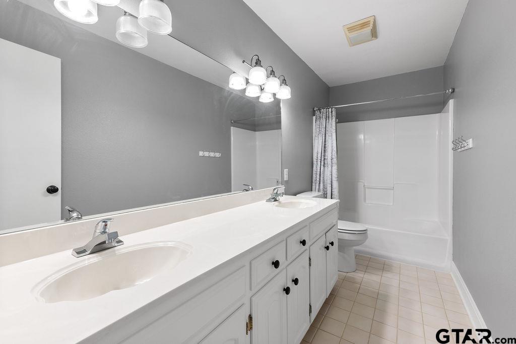1102 Lilly Lane Bullard, TX 75757 - Photo 18 of 48 a bathroom with double vanity sink and a mirror