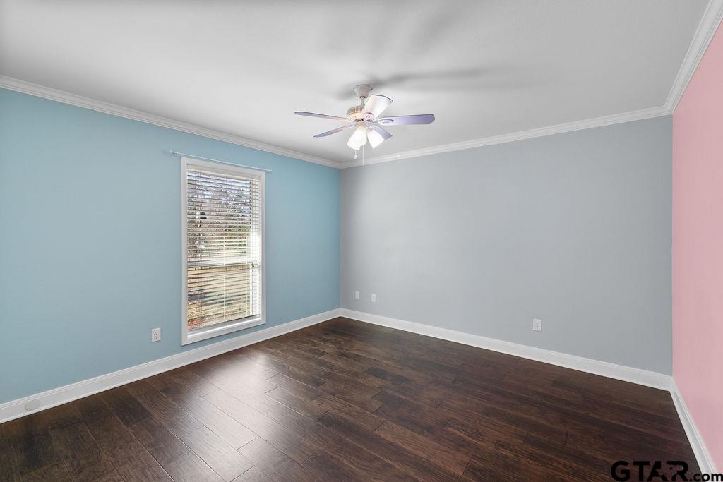 1102 Lilly Lane Bullard, TX 75757 - Photo 19 of 48 an empty room with wooden floor chandelier fan and windows
