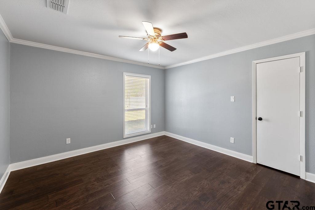 1102 Lilly Lane Bullard, TX 75757 - Photo 21 of 48 a view of an empty room with wooden floor and a window