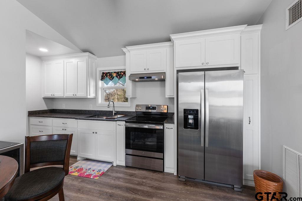 1102 Lilly Lane Bullard, TX 75757 - Photo 24 of 48 a kitchen with stainless steel appliances granite countertop a refrigerator and a stove top oven