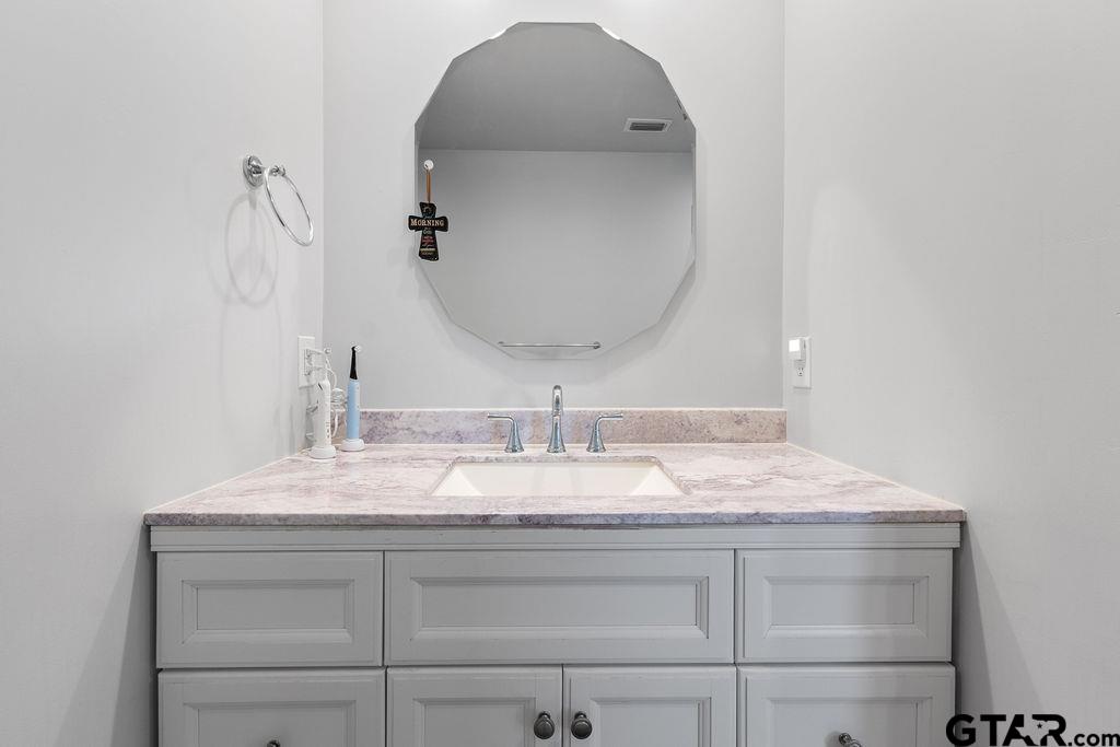 1102 Lilly Lane Bullard, TX 75757 - Photo 32 of 48 a bathroom with a sink and a mirror