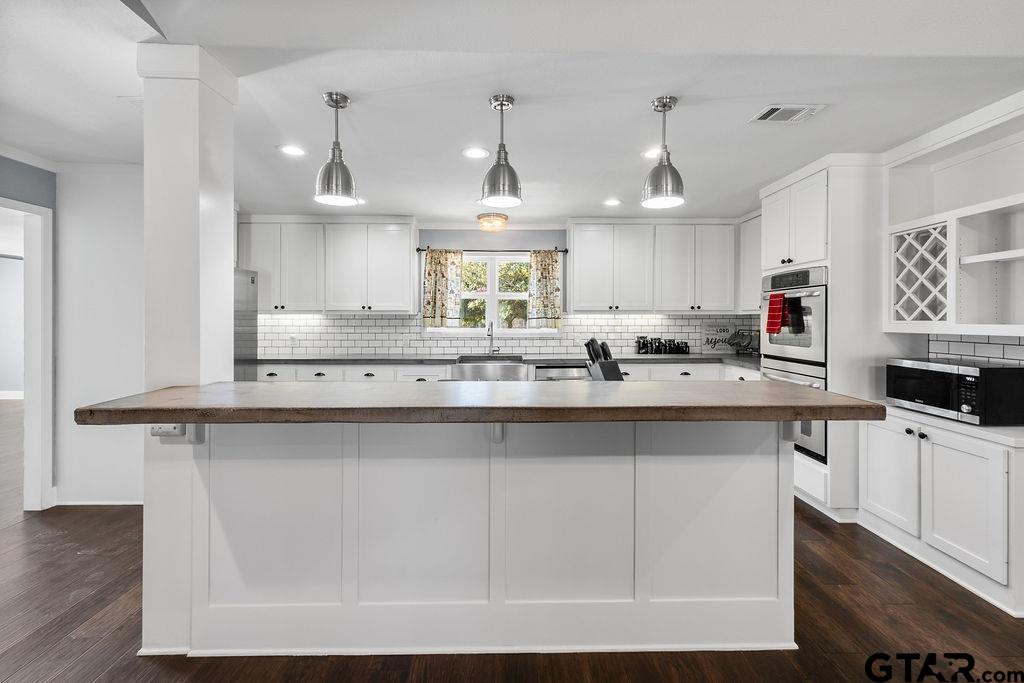 1102 Lilly Lane Bullard, TX 75757 - Photo 4 of 48 a kitchen with stainless steel appliances a sink a stove and cabinets