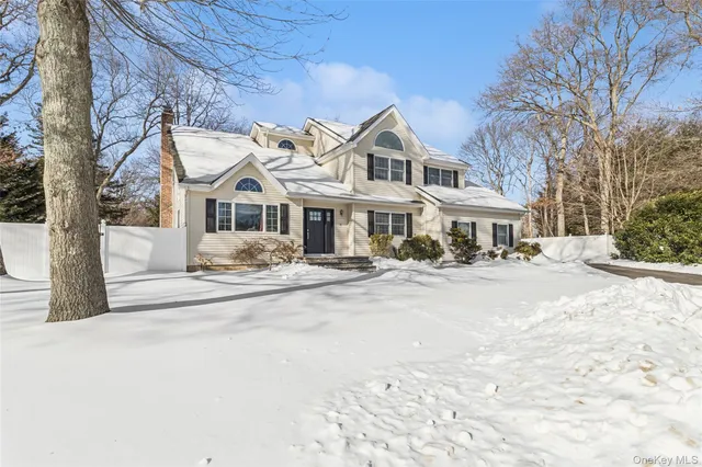 a front view of a building with a lot of cars parked on road
