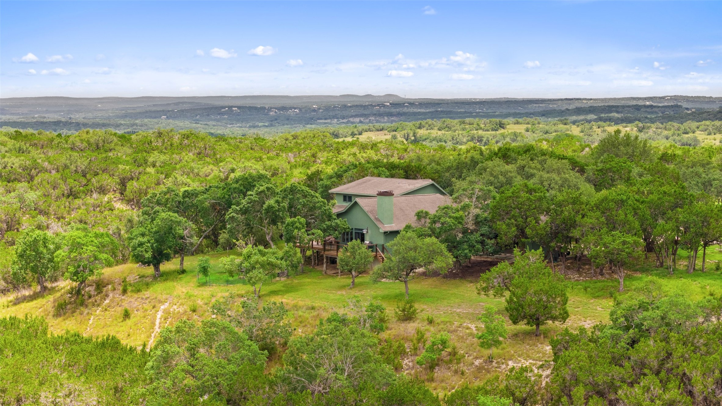 505 Red Corral Ranch Road Wimberley, TX 78676 - Photo 5 of 40 Nestled among lush greenery, this secluded home offers a private escape with expansive views.