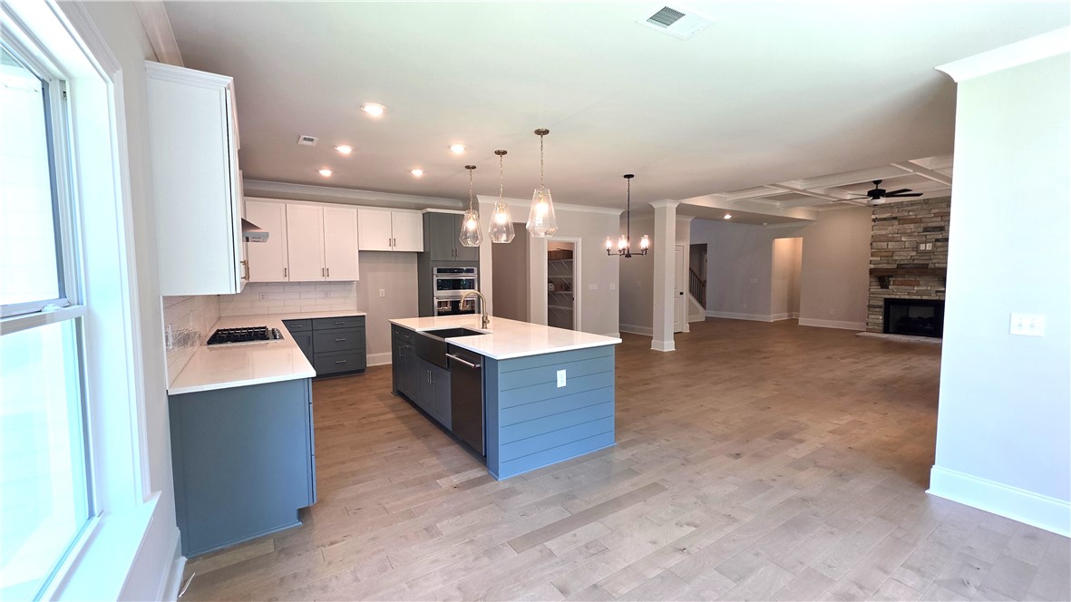 243 Holly Br Road Piedmont, SC 29673 - Photo 11 of 21 A contemporary kitchen and living area feature an inviting open-concept layout.