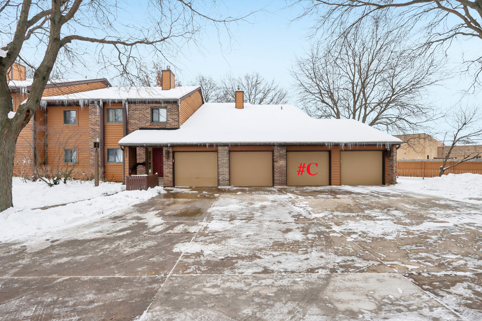 655 Waverly Drive, Unit C Elgin, IL 60120 - Photo 3 of 21 a front view of a house with a yard and garage