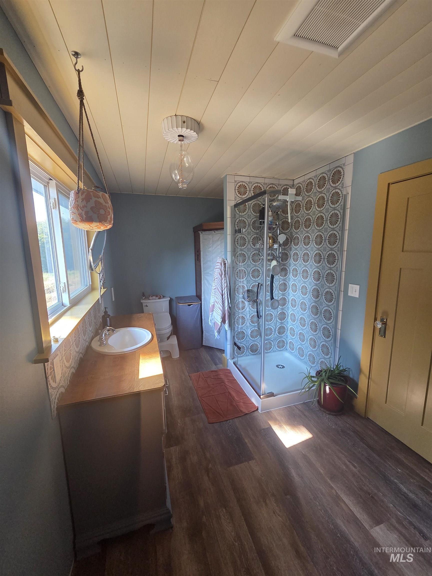 870 Dutch Flat Road Pomeroy, WA 99347 - Photo 21 of 33 Full bathroom featuring a stall shower, vanity, dark wood finished floors, and wood ceiling