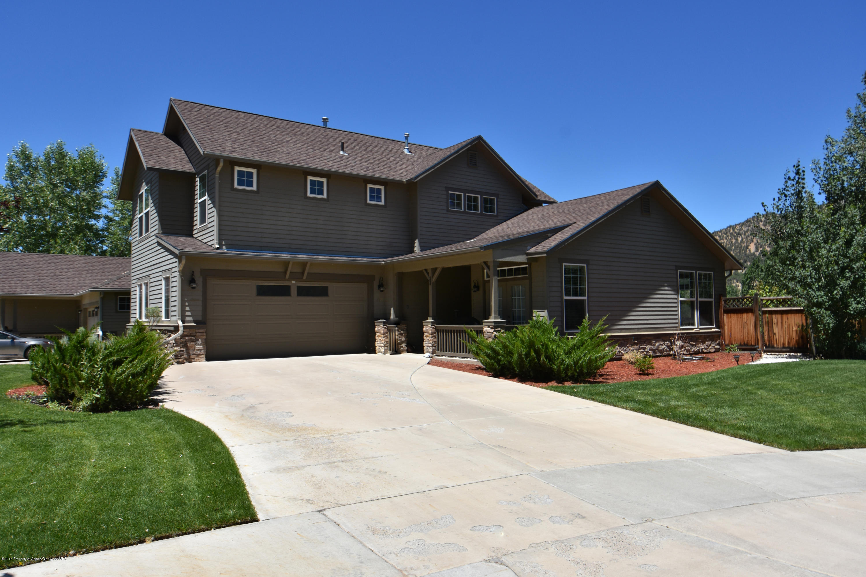 118 Carson Court New Castle, CO 81647 - Photo 1 of 26 a front view of a house with a yard and garage