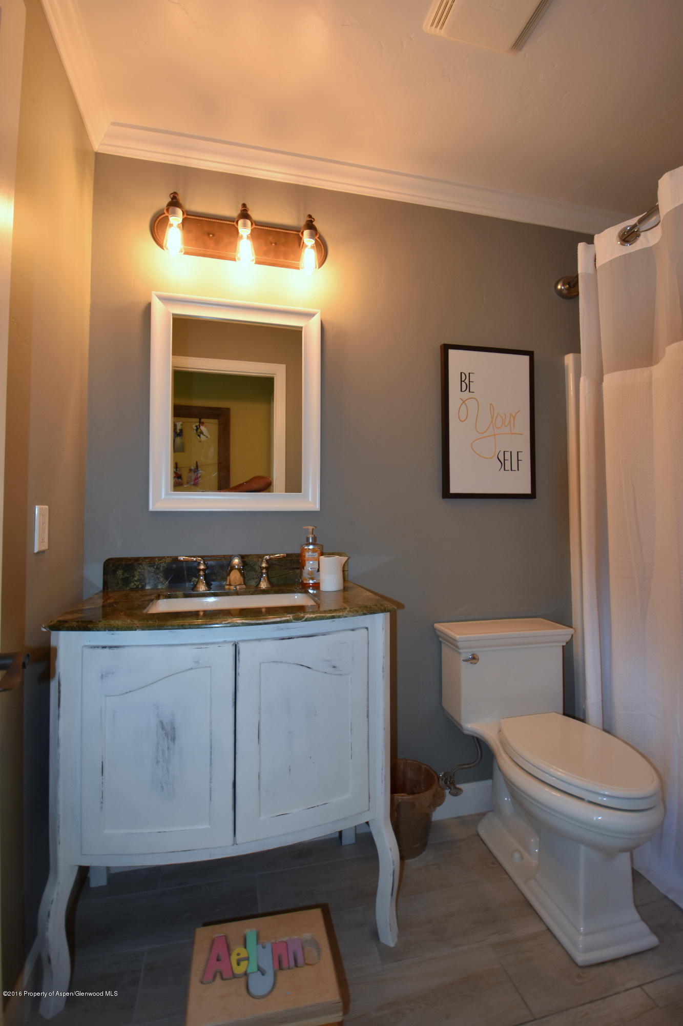118 Carson Court New Castle, CO 81647 - Photo 16 of 26 a bathroom with a toilet a sink and mirror