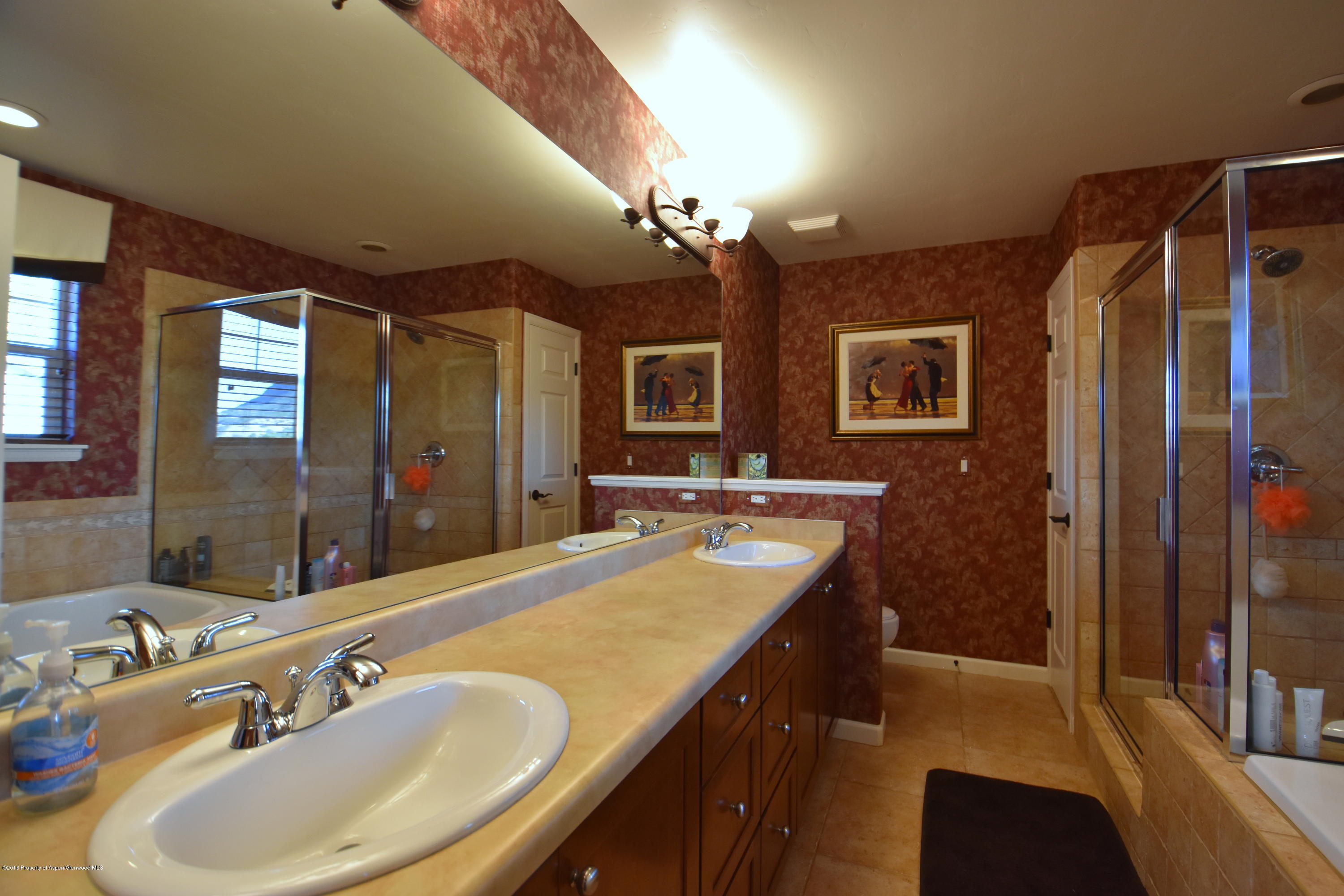 118 Carson Court New Castle, CO 81647 - Photo 19 of 26 a bathroom with a sink double vanity granite tub shower and a mirror