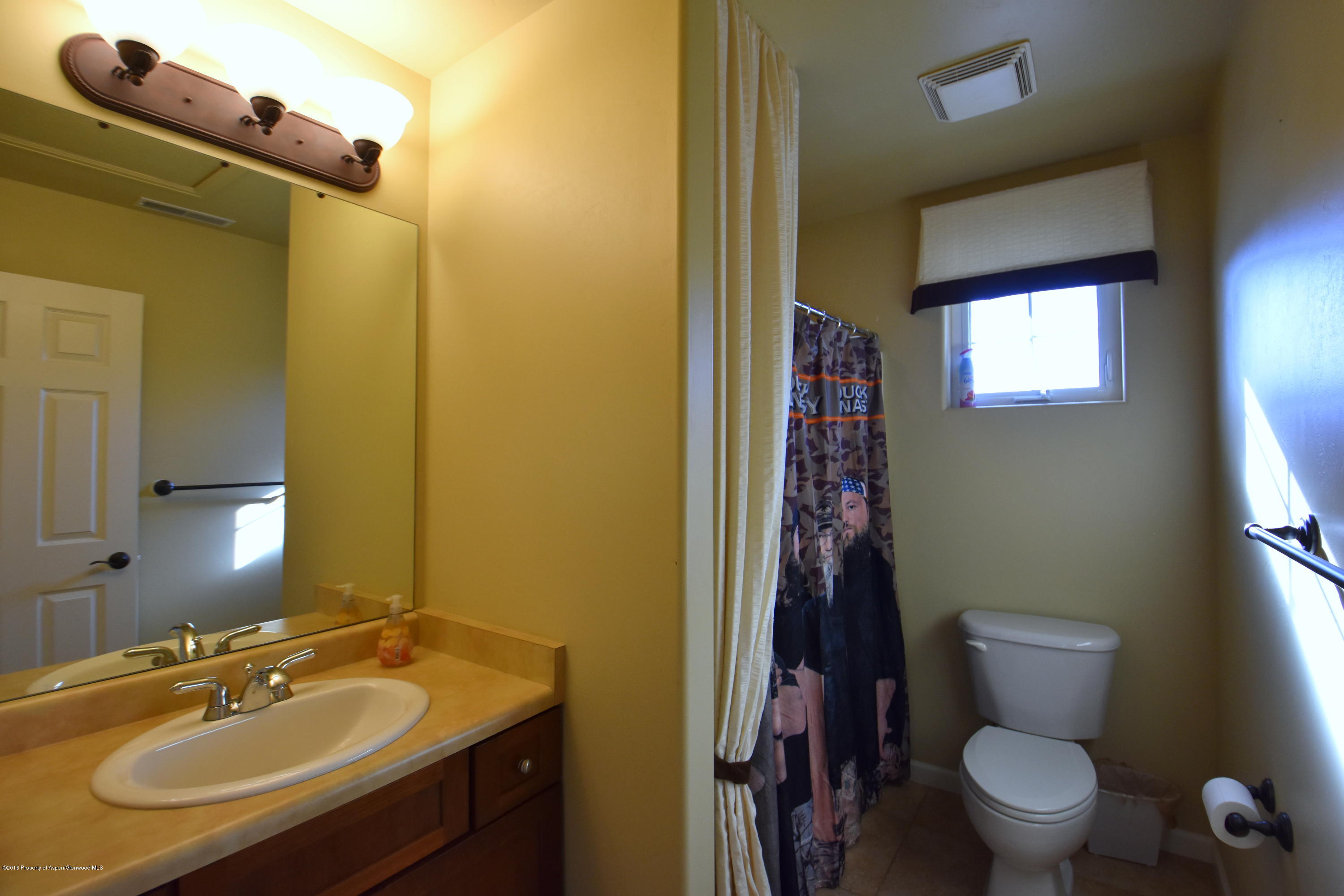 118 Carson Court New Castle, CO 81647 - Photo 25 of 26 a bathroom with a sink toilet and shower
