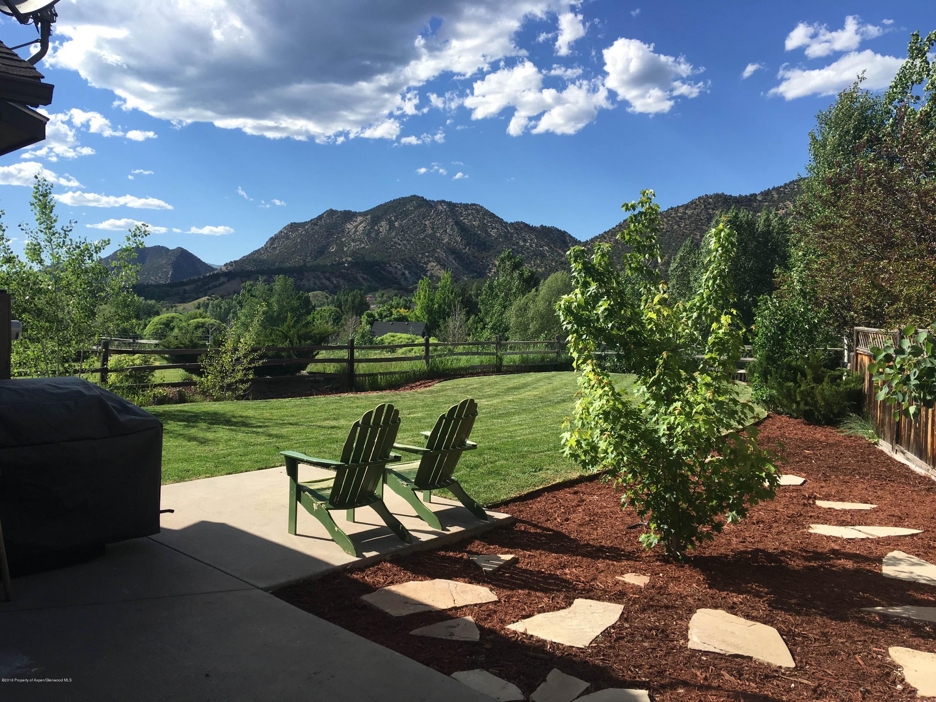 118 Carson Court New Castle, CO 81647 - Photo 3 of 26 a view of a garden with lawn chairs