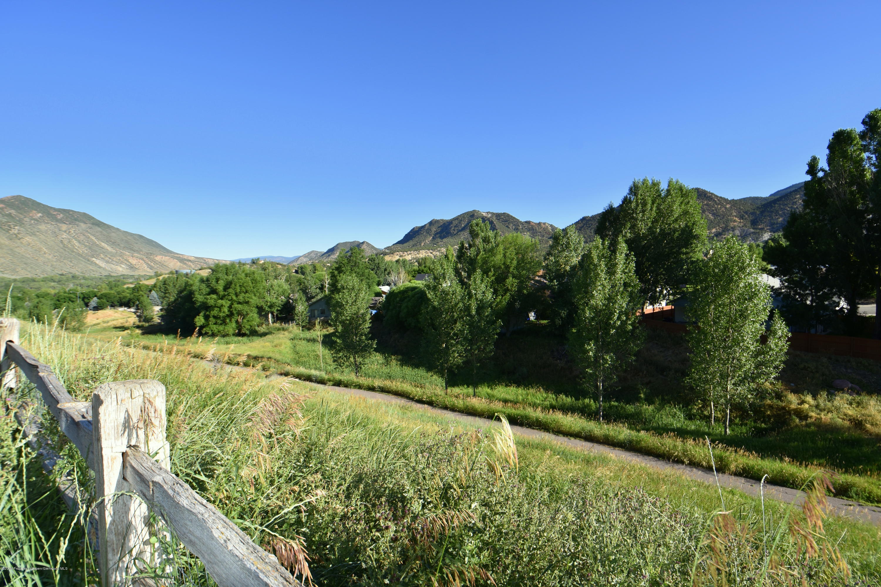 118 Carson Court New Castle, CO 81647 - Photo 7 of 26 a view of a garden with a building in the background