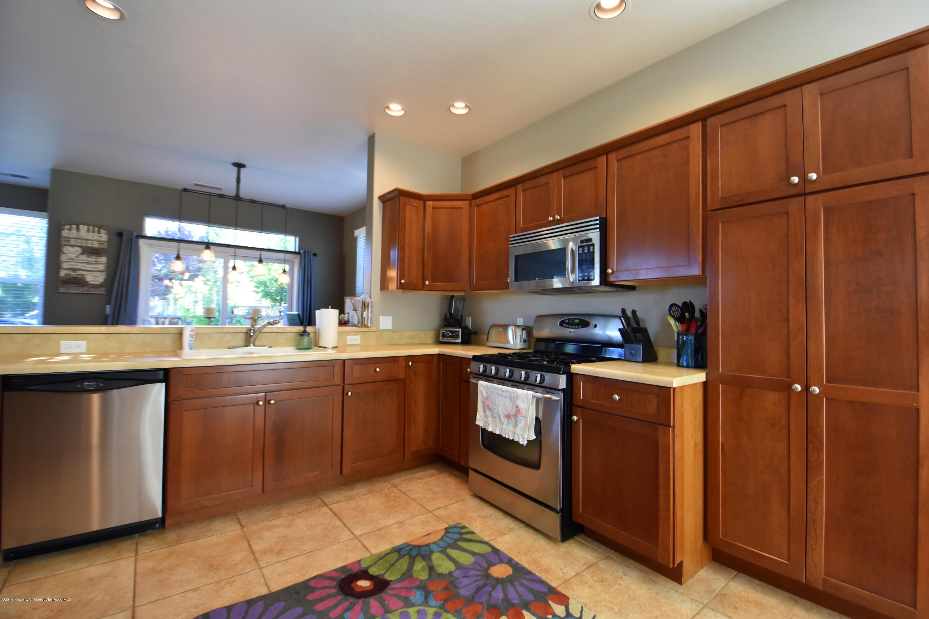 118 Carson Court New Castle, CO 81647 - Photo 8 of 26 a kitchen with stainless steel appliances granite countertop a sink stove and refrigerator