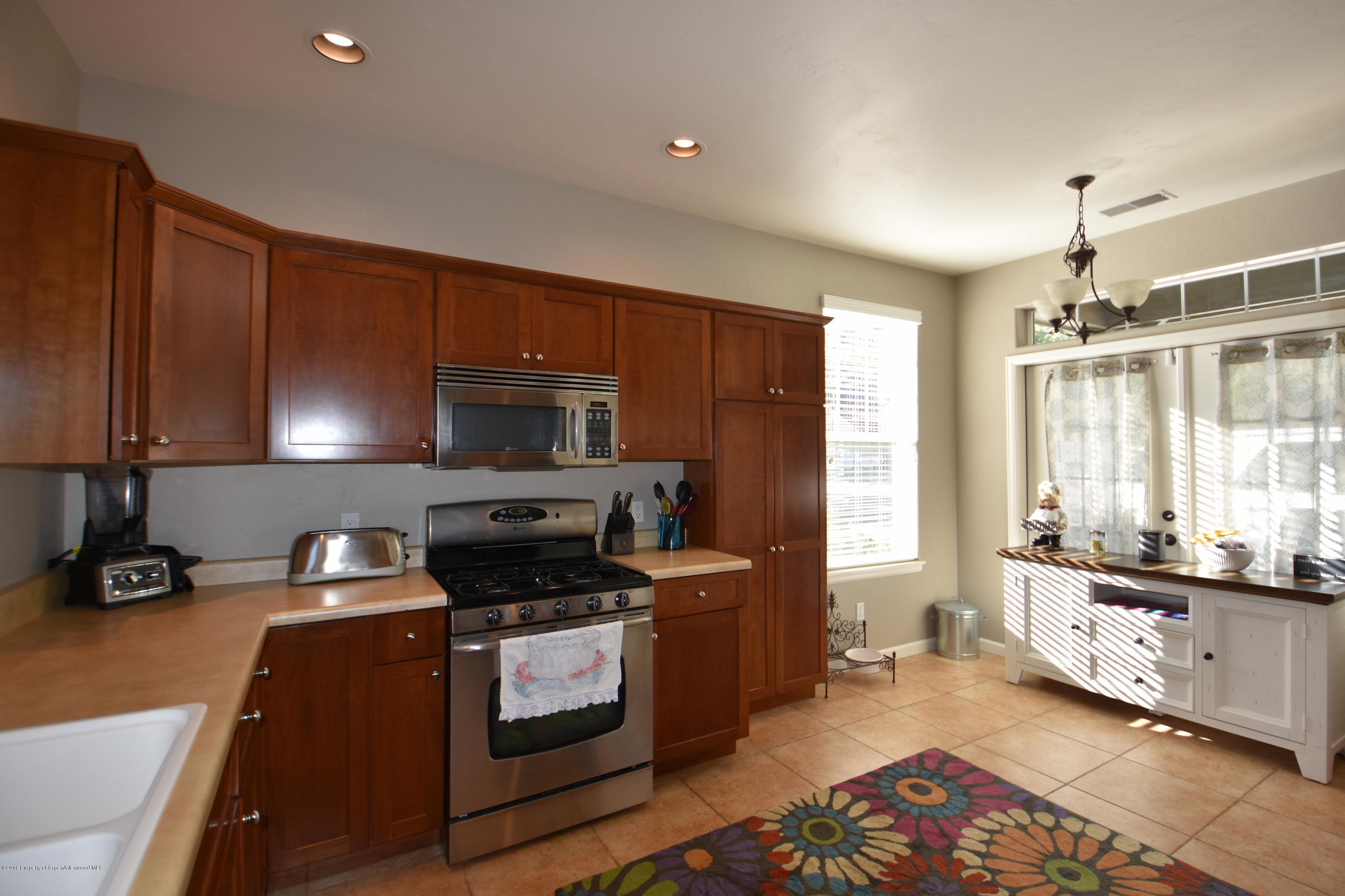 118 Carson Court New Castle, CO 81647 - Photo 9 of 26 a kitchen with stainless steel appliances a stove a sink and a refrigerator