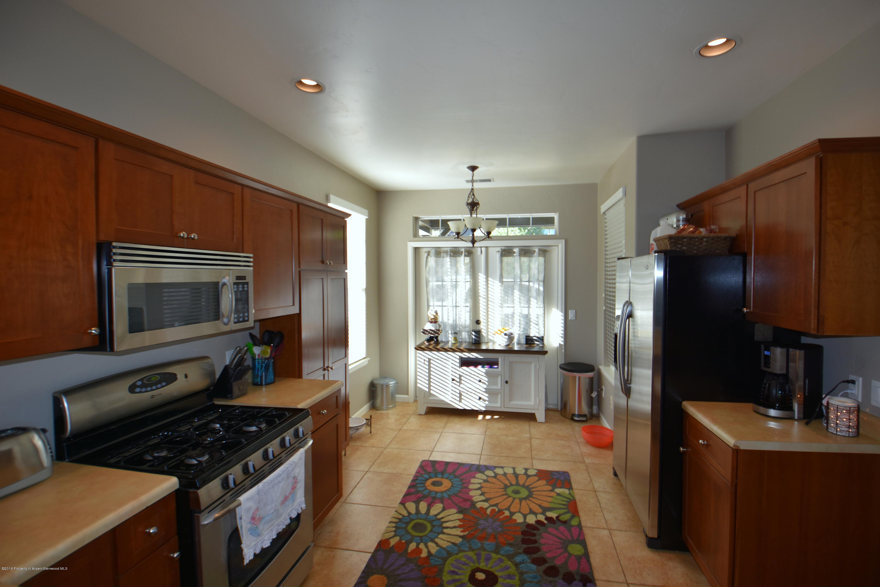 118 Carson Court New Castle, CO 81647 - Photo 10 of 26 a kitchen with a stove a refrigerator and furniture