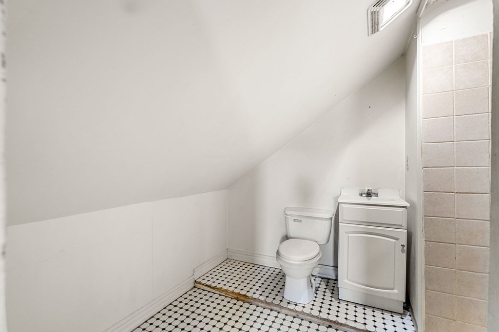 29 Harding Avenue Everett, MA 02149 - Photo 12 of 32 a bathroom with a toilet a sink a vanity and mirror