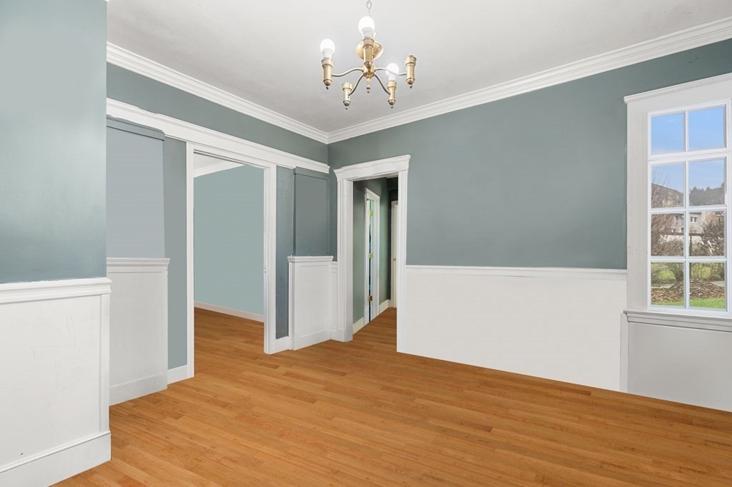 29 Harding Avenue Everett, MA 02149 - Photo 21 of 32 a view of a hallway with wooden floor and a chandelier