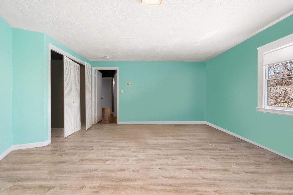 29 Harding Avenue Everett, MA 02149 - Photo 23 of 32 a view of an empty room with wooden floor and a window